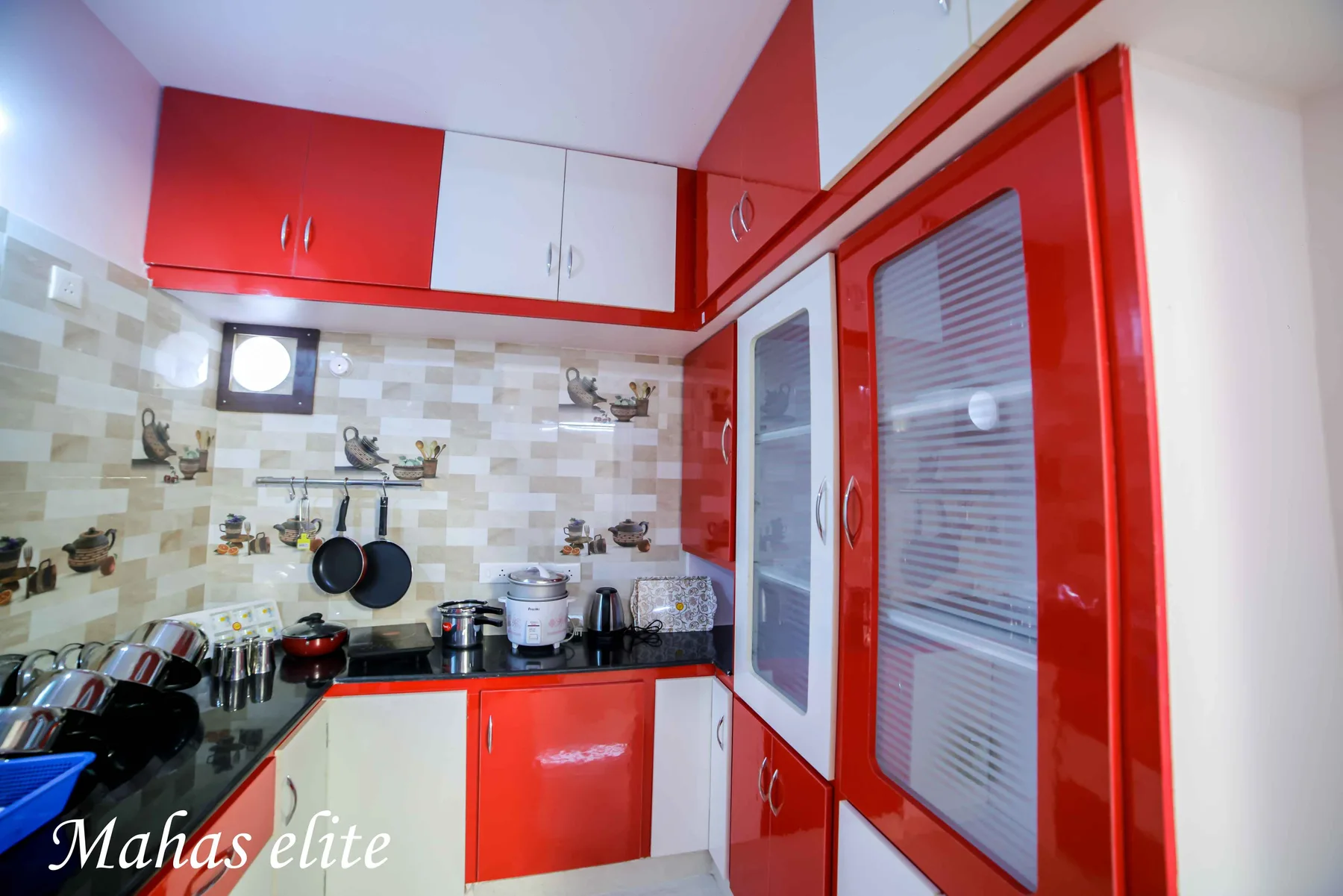 Kitchen with induction cooking facility at Mahas Elite