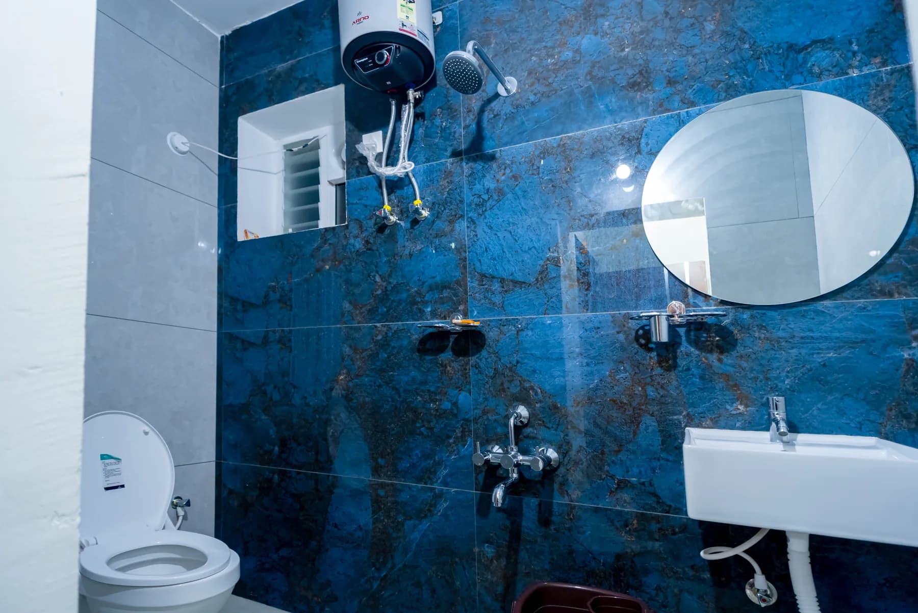 Bathroom with geyser at Mahas Vrindavan family apartment