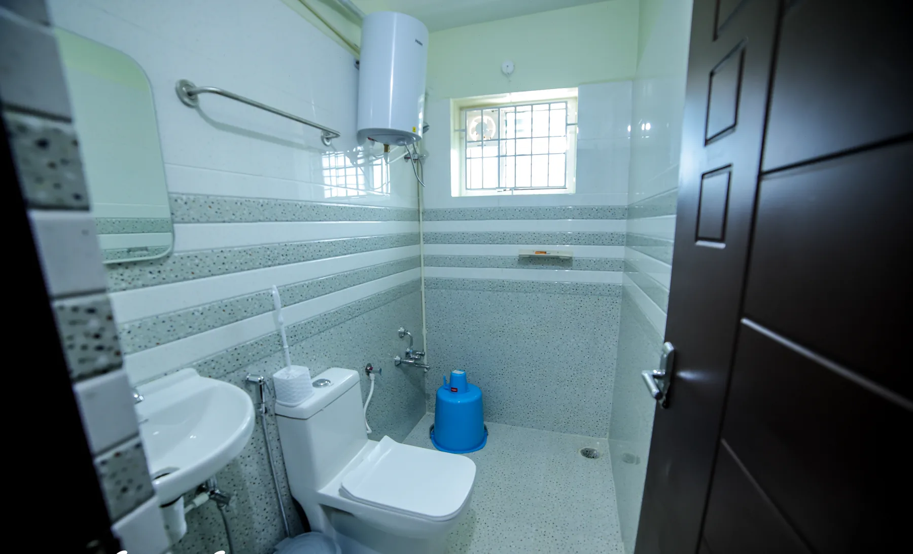 Clean bathroom with geyser at Mahas Elite